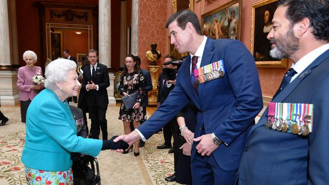 Queen Elizabeth II shakes hands with Ben Roberts-Smith VC during a reception for the Victoria Cross and George Cross Association at in the Picture Gallery at Buckingham Palace in May 2018 in London. Photo: John Stillwell