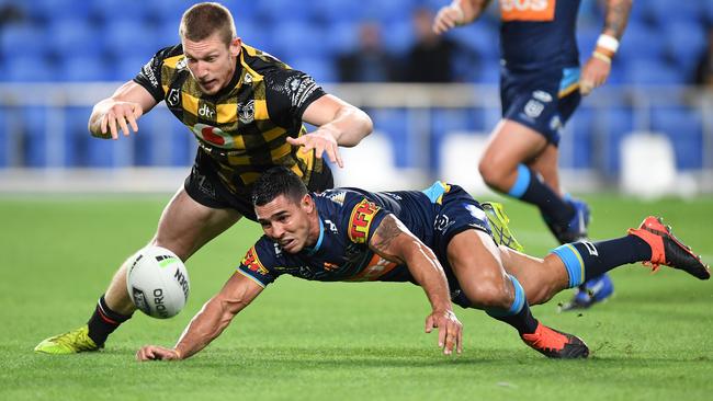 Jamal Fogarty and Jack Hetherington compete for the ball during a try-scoring opportunity.