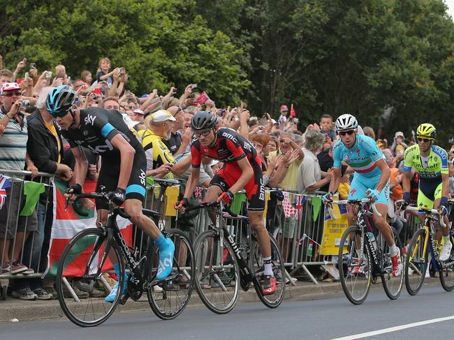 Chris Froome (L) of Great Britain and Team Sky leads the race as he attacks on the final climb and claims the points at the top of the Cote de Jenkins Road.