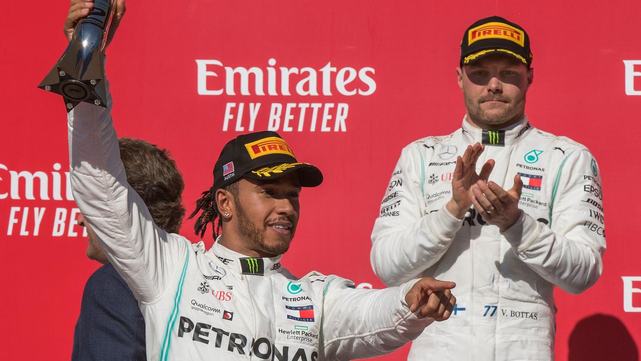 Valtteri Bottas looks on as Lewis Hamilton celebrates. Picture: Mark Ralston