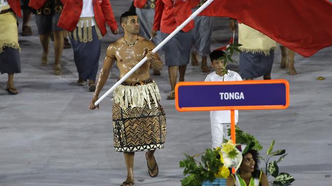 Pita Nikolas Taufatofua carries the flag of Tonga during the opening ceremony for the 2016 Summer Olympics in Rio de Janeiro, Brazil. Picture: AP/Matt Slocum.