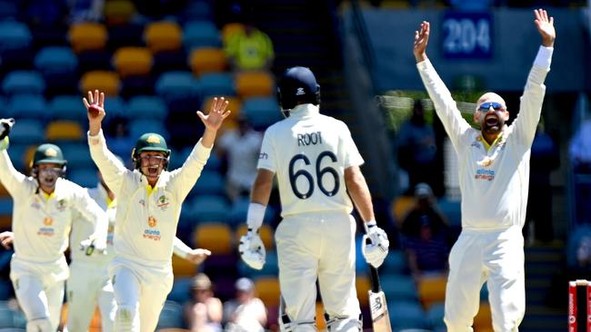 Nathan Lyon, celebrates taking his 400th Test wicket after dismissing Dawid Malan on day four at the Gabba. Picture: Getty Images