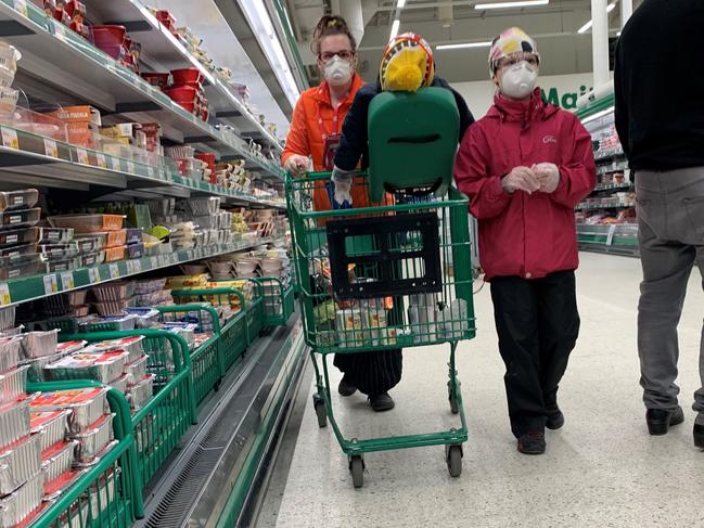 Wearing gloves and face masks is unnecessary in supermarkets if you practise good hand hygiene. Picture: AFP