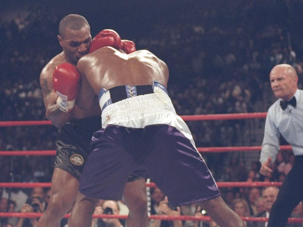 Evander Holyfield and Mike Tyson lock heads during their heavyweight title fight at the MGM Grand Garden in 1997.