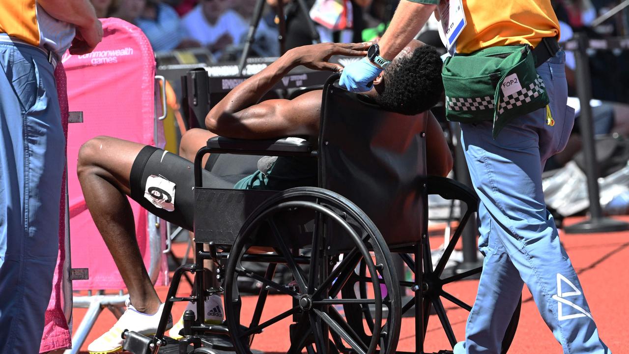 Zambia's Muzala Samukonga is carried on a wheelchair. Photo by Andy Buchanan / AFP.