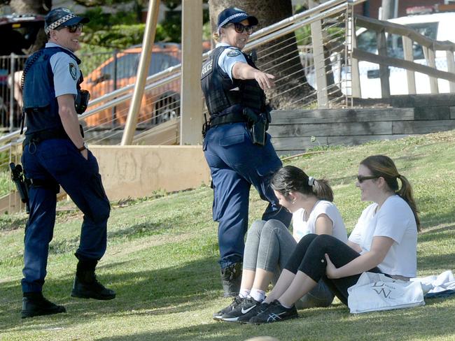 Police check on beachgoers as social distancing regulations continue at Dee Why Beach. Picture: Jeremy Piper