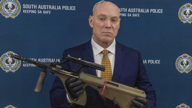 Detective Superintendent Steve Taylor last year with a rifle seized during an organised crime investigation. Picture: Roy Van Der Vegt