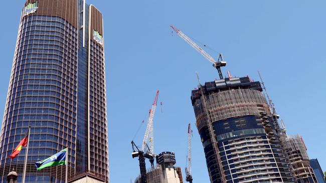 Constructions crane working above the Queens Wharf Casino project and 1 William Street tower (left). Picture: David Clark