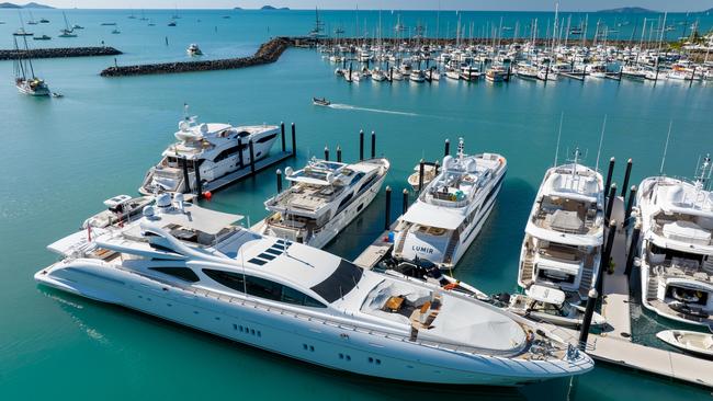 Superyachts berthed at Coral Sea Marina Resort in Airlie Beach, QLD.