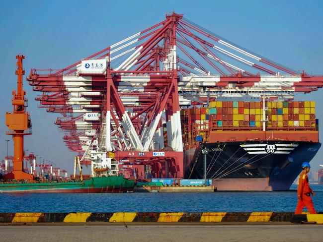 A cargo ship is seen at a port in Qingdao in China's eastern Shandong province on October 12, 2018. - China's trade surplus with the United States ballooned to a record 34.1 billion USD in September despite a raft of US tariffs, official data showed on October 12, adding fuel to the spiralling trade war. (Photo by STR / AFP) / China OUT