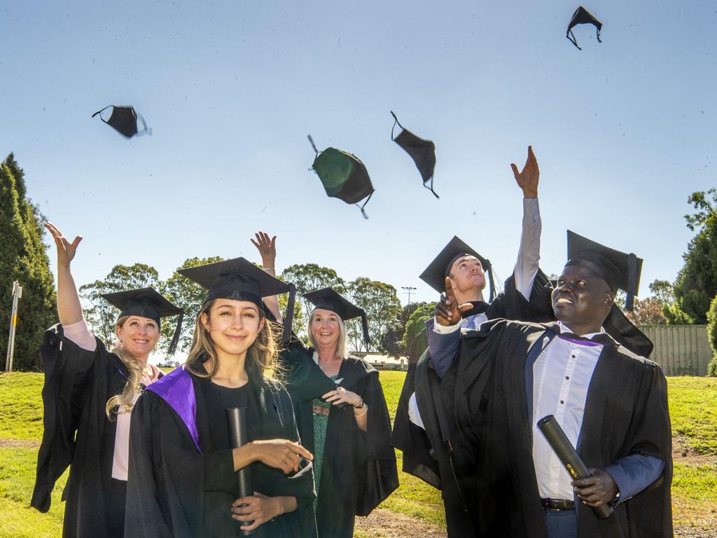 With the first USQ graduation ceremony in over a year, over 1000 students have successfully been capped, gowned and handed their degrees following a particularly difficult period of study. Wednesday afternoon’s graduates, (from left) Tiffany Louise Ozherelyeva (Bachelor of Laws), Michelle Fanning (Bachelor of Laws), Lisa Stone (Bachelor of Social Science, Ocholamero Oroto (Juris Doctor) and Nathan Harvey (Bachelor of Social Science). Picture: Nev Madsen.