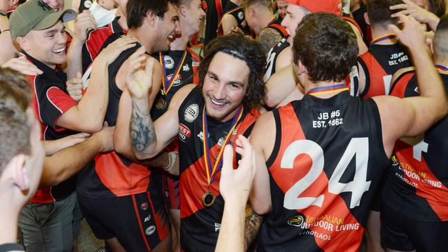 Tea Tree Gully great Alex McKay celebrates a division one flag. Picture: Brenton Edwards