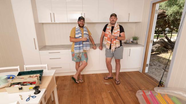 The beach box has a kitchenette and will be sold with a dining table, four chairs, two beach lounges, a side table, and even a bottle of champagne. Picture: Tony Gough