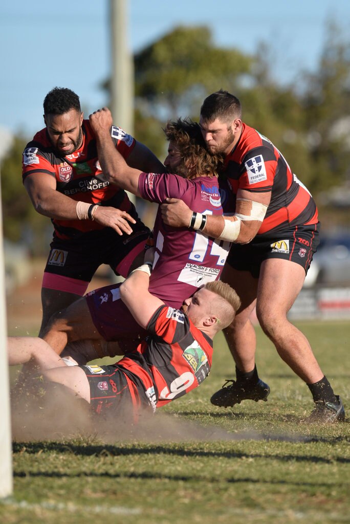 Jason Wardrop of Dalby Diehards is wrapped up by Valleys Roosters in TRL Premiership qualifying final rugby league at Glenholme Park, Sunday, August 12, 2018. Picture: Kevin Farmer