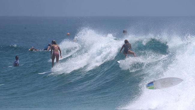 Surfers enjoy large waves at Snapper Rocks .Picture Mike Batterham