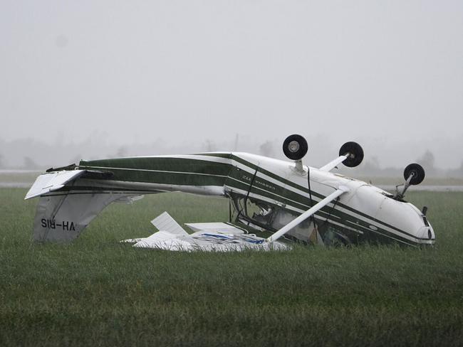 A plane flipped at Bowen Airport, Queensland, Wednesday, March 29, 2017. The coastal Queensland town of Bowen has found itself largely intact in the wake of Tropical Cyclone Debbie. Picture: AAP Image/Sarah Motherwell