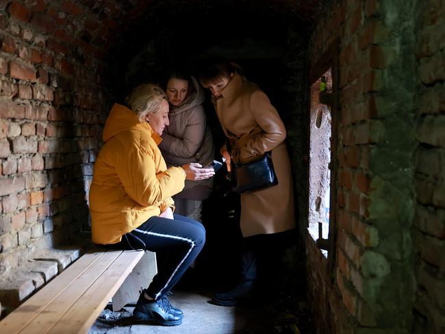 Women take shelter after an air raid siren sounded in Lviv, Ukraine. Picture: Getty Images