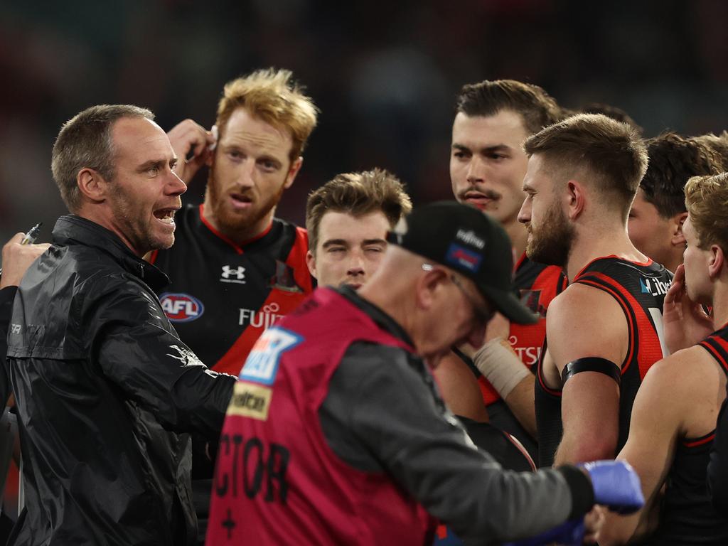 Bombers coach, Ben Rutten speaks to the players at the break during the round 13 AFL match between the Essendon Bombers and the Carlton Blues. Picture: Robert Cianflone/Getty Images