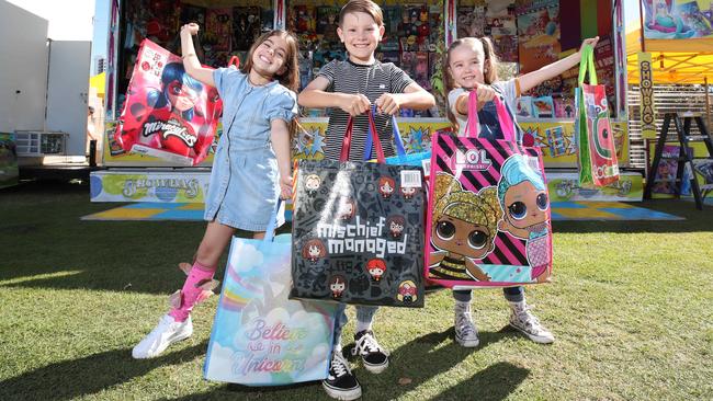 The Gold Coast Show starts Thursday and locals Ayla Shephard 8, Van Taurima 8, and Pippa Tucker 8, with Showbags. Picture Glenn Hampson