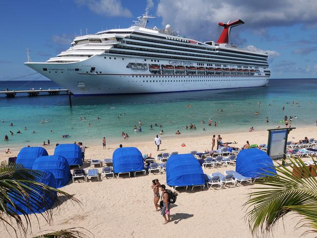 In this photo released by Carnival Corp. & plc, passengers aboard the Carnival Destiny enjoy the beach at the Grand Turk Cruise Terminal Wednesday, Oct. 8, 2008, in Grand Turk, Turks and Caicos. The arrival of Carnival Destiny marked the first time a cruise ship has called at Grand Turk since prior to Hurricane Ike's devastating blow to the island a month ago. Carnival imported temporary housing, food, supplies, foliage and supplemental labor to effect repairs to the facility to reopen it for cruise passengers. (AP Photo/Carnival Corp. & plc, Andy Newman)