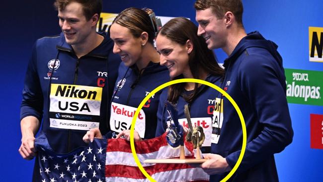 USA team members pose with the best team trophy during the swimming event at the World Aquatics Championships in Fukuoka on July 30, 2023. (Photo by Philip FONG / AFP)`