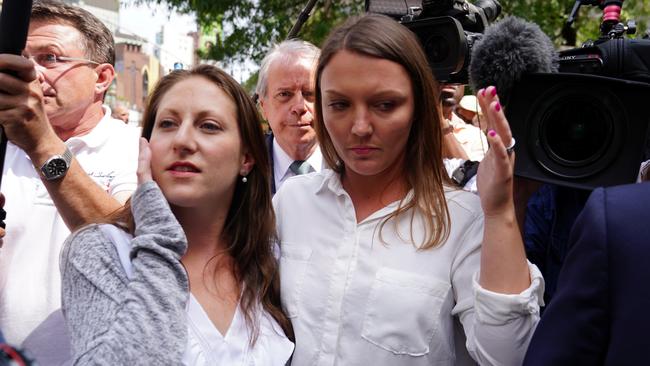 Michelle Licata and Courtney Wild, who say they are victims, leave following the arraignment of US financier Jeffrey Epstein.