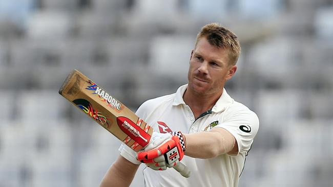 Australia's David Warner acknowledges the crowd after scoring a century.