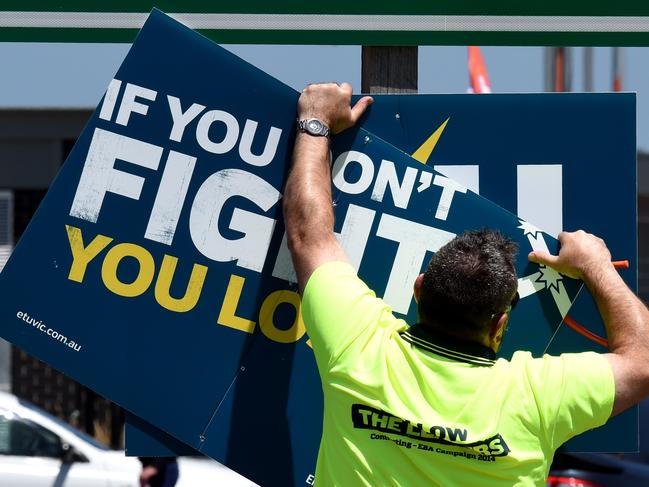 A protester takes doen the signs.  Protest at Webb Dock pack up and remove the blockade.  Picture: Nicole Garmston