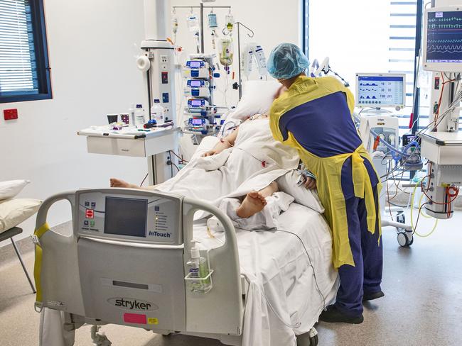 NOT TO BE USED WITHOUT PERMISSION - FOR SEPT 18, 2021 Northern Beaches Hospital - Covid-19 Feature. RN Franz Brana attends to a Covid-19 patient. In the ICU-C ward.  Picture Chris Pavlich for The Manly Daily