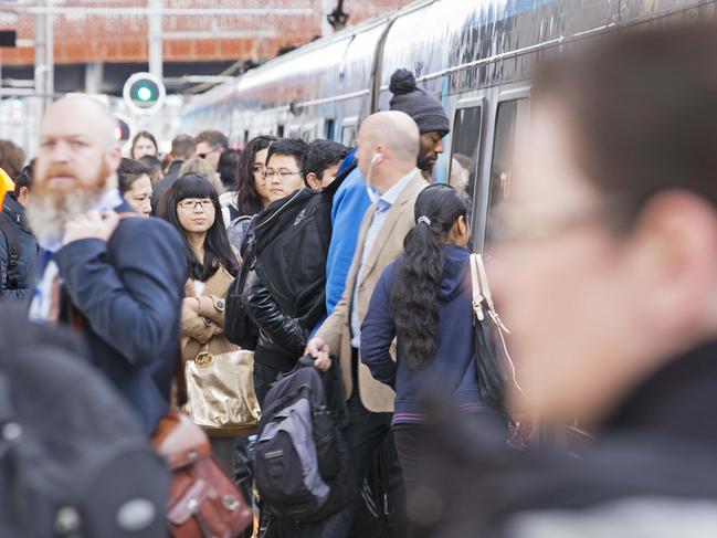 Commuters crowd the platform at North Melbourne Station. Picture: Nathan Dyer