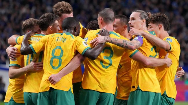 SAITAMA, JAPAN - OCTOBER 15: Australia players celebrate after Shogo Taniguchi of Japan (not pictured) scores an own goal to make it the first goal for Australia during the FIFA World Cup Asian Third Qualifier Group C match between Japan and Australia at Saitama Stadium on October 15, 2024 in Saitama, Japan.  (Photo by Koji Watanabe/Getty Images)