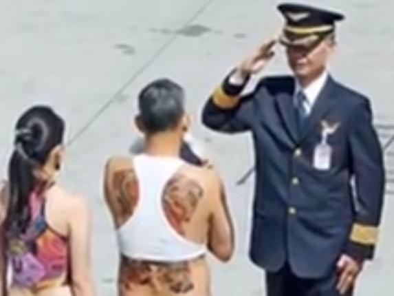 Thailand's crown prince Maha Vajiralongkorn in a crop top and fake tattoos.