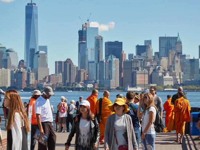 New York - September 12, 2016: People and tourists shooting photos and looking at New York city skyline from Liberty island in a sunny day in New York.