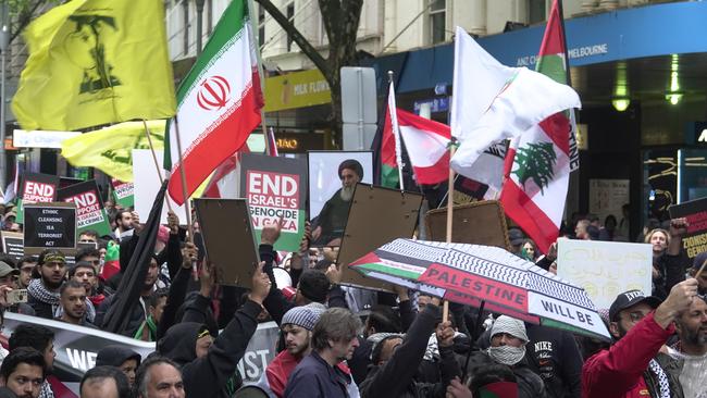 Melbourne protesters carry Hezbollah flags and photos of the assassinated leader of the terror group, Hassan Nasrallah. Picture: NCA NewsWire / Valeriu Campan