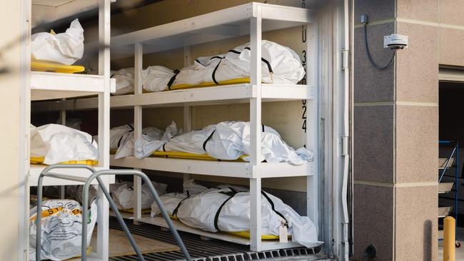 Warning: graphic content. Bodies wrapped in plastic line the walls inside a refrigerated trailer used as a mobile morgue in El Paso, Texas, last month. The coronavirus outbreak has been worsening in the northern winter in the US. Picture: AFP