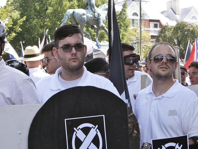 James Alex Fields Jr, left, holds a black shield belonging to the White Supremacist group Vanguard America. Picture: Alan Goffinski/AP