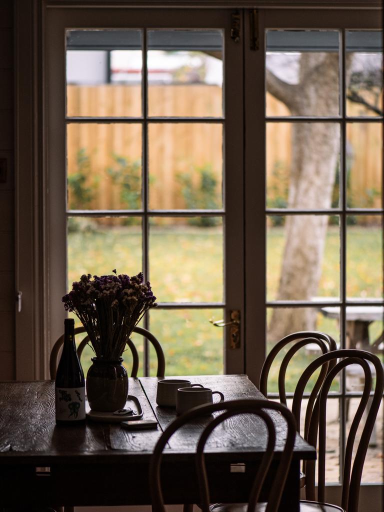 The open-plan kitchen and dining area looks out onto the cottage garden and contains full amenities to allow guests to whip up a culinary feast. Picture: Em Godfrey