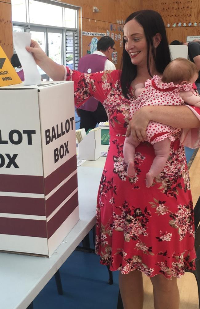 Labor Member for Keppel Brittany Lauga casts her vote with daughter Odette yesterday.