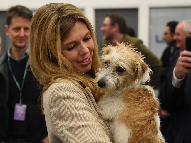 Carrie Symonds, with the couple’s dog Dilyn on election night, shared her exciting news on Instagram. Picture: AFP