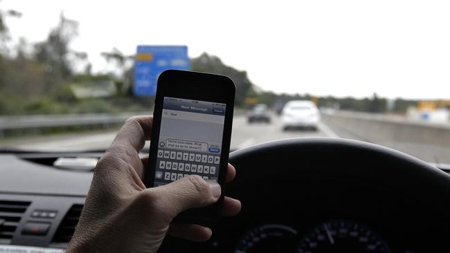 Parents are putting their kids at risk by using their phone behind the wheel.