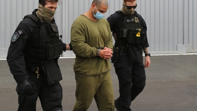 Alleged drug smuggler Mostafa Baluch was led to a NSW Police plane on the Gold Coast wearing shackles and prison greens on Thursday. Picture: NSW Police