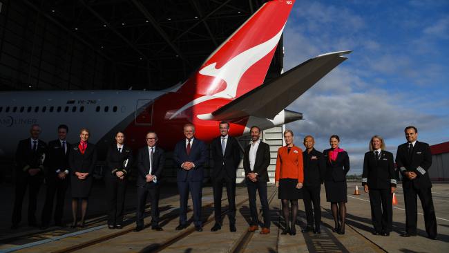 Qantas CEO Alan Joyce (fifth left), Prime Minister Scott Morrison (middle left), NSW Premier Dominic Perrottet (middle right) and Jetstar CEO Gareth Evans (sixth right) pose for a photograph with Qantas and Jetstar employees during a press conference at the Qantas Jet Base at Sydney Airport on Friday. Picture: NCA NewsWire/Bianca De Marchi