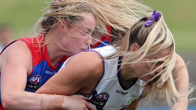 There was plenty of rough and tumble in an even match, with Fremantle’s Hayley Miller copping the full force of Bulldog Aisling McCarthy’s strength. Picture: Michael Klein