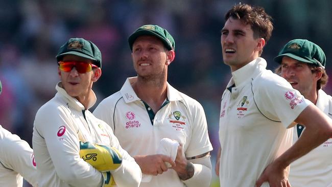 (L-R) Australia captain Tim Paine, plus bowlers James Pattinson and Pat Cummins watch the scoreboard during the DRS review. Picture: AFP