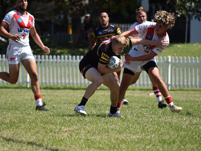 Luke Hanson is tackled by Shadi Hammoud in the SG Ball Cup. Picture: Sean Teuma/NewsLocal