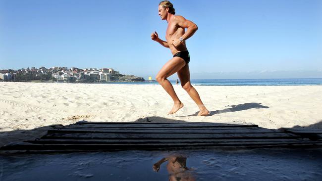 Ironman legend Guy Leech jogging at Bondi Beach in Sydney.