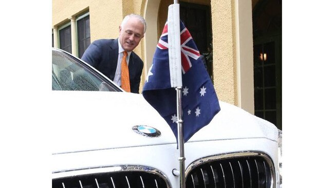 Malcolm Turnbull hoping into the offical PM's car.