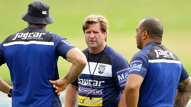 Coach Des Hasler with his assistants during training.