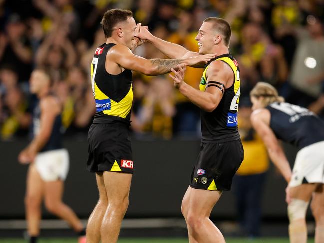 MELBOURNE, AUSTRALIA - MARCH 13: Richmond debutant Sam Lalor (R) celebrates with teammate Rhyan Mansell after the siren during the 2025 AFL Round 01 match between the Richmond Tigers and the Carlton Blues at the Melbourne Cricket Ground on March 13, 2025 in Melbourne, Australia. (Photo by Dylan Burns/AFL Photos via Getty Images)