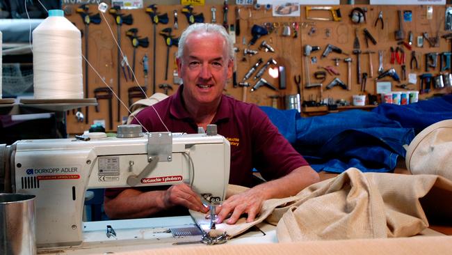 Andrew McGauchie working at his business, McGauchie Upholstery.